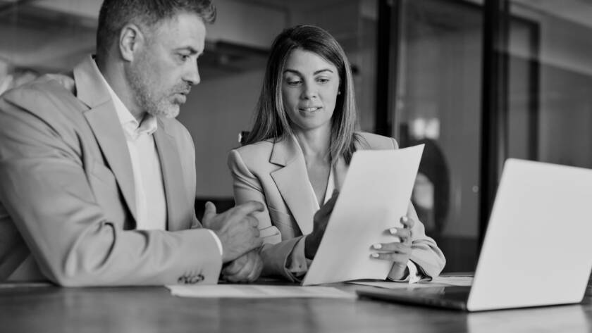 CPA and client in front of a laptop discussing possible risks associated with BOI compliance.